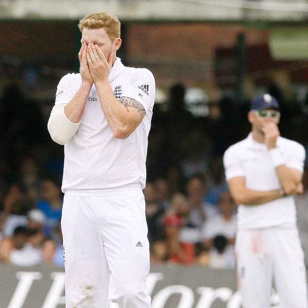 England's Ben Stokes, left, holds his face as India's Ravindra Jadeja adds runs during the fourth day of the second test match between England and India at Lord's cricket ground in London, Sunday, July 20, 2014. 