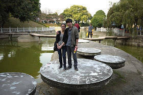 Couple standing on a platform in a pond at Jingshan Park in Zhuhai