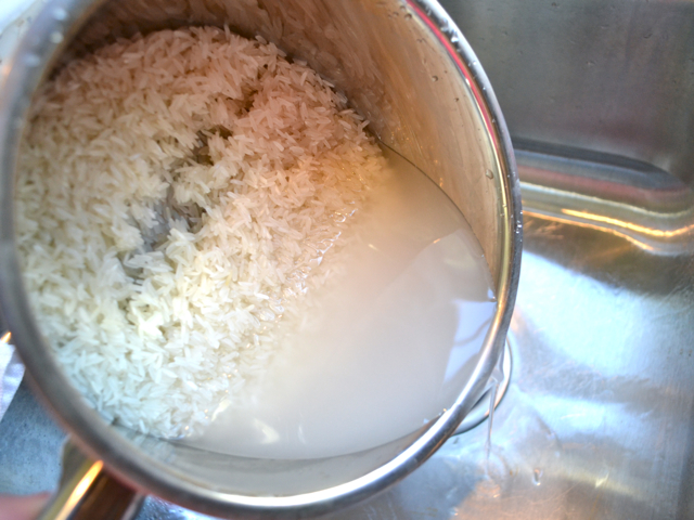 rice covered with warm water in pot 