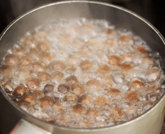 step by step photo of tapioca pearls boiling in sugar water