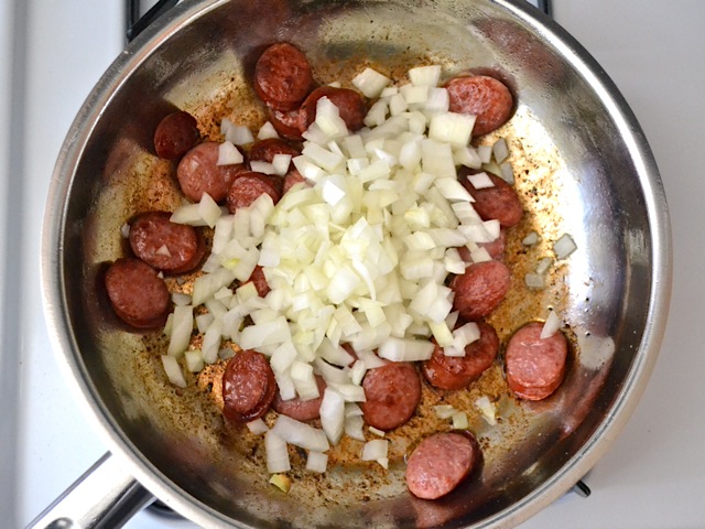 diced onion added to skillet with sausage 