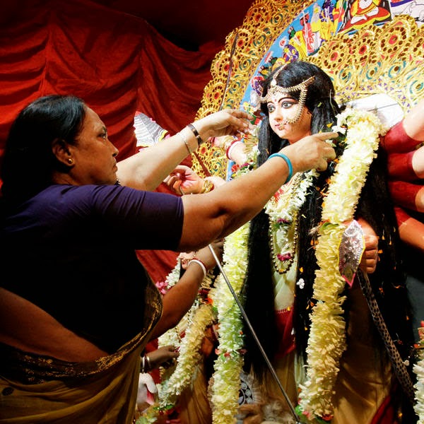 An Indian sex worker garlands an idol of Hindu goddess Durga at a worship place set up by sex workers at Sonagachhi, a red light district, in Kolkata.