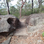 Walking between boulders towards Red Hands Cave (145446)