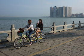 two young women on a twin tandem bicycle in Zhuhai, China