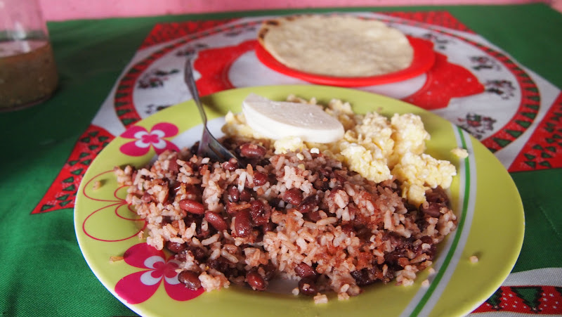 Typical Nicaragua breakfast: rice and beans, scrambled egg, cheese, and tortillas.