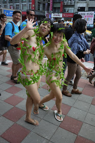 same two young women who are dressed with minimal covering and vines