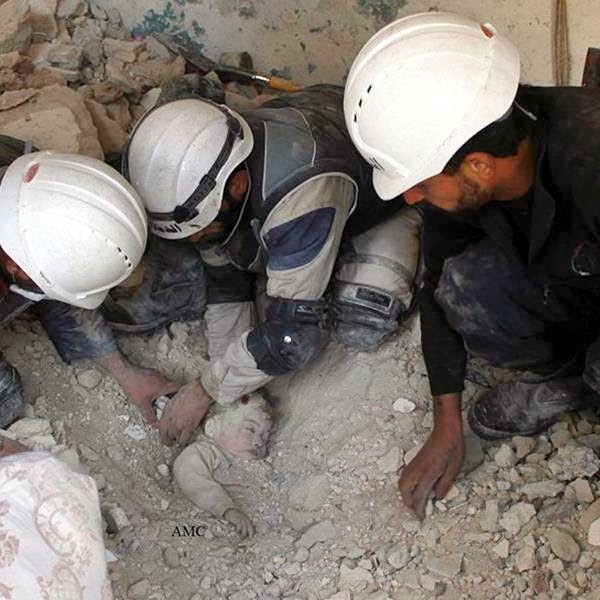 An anti-Bashar Assad activist group, which has been authenticated based on its contents and other AP reporting, Syrian rescue workers dig out the lifeless body of a young child from the rubble of a building damaged by Syrian government forces attacks, in Aleppo, Syria. 