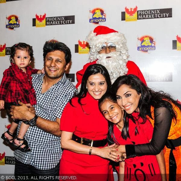 Mouli Ganguly (R) poses with Smita Bansal, Ankush Mohla and their daughters during pre-christmas party, held at Amoeba, in Mumbai, on December 18, 2013.