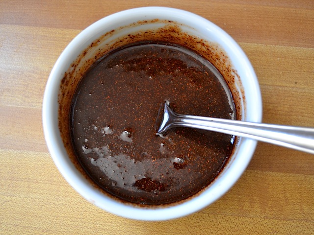 honey spice mixture stirred together in small bowl with spoon 