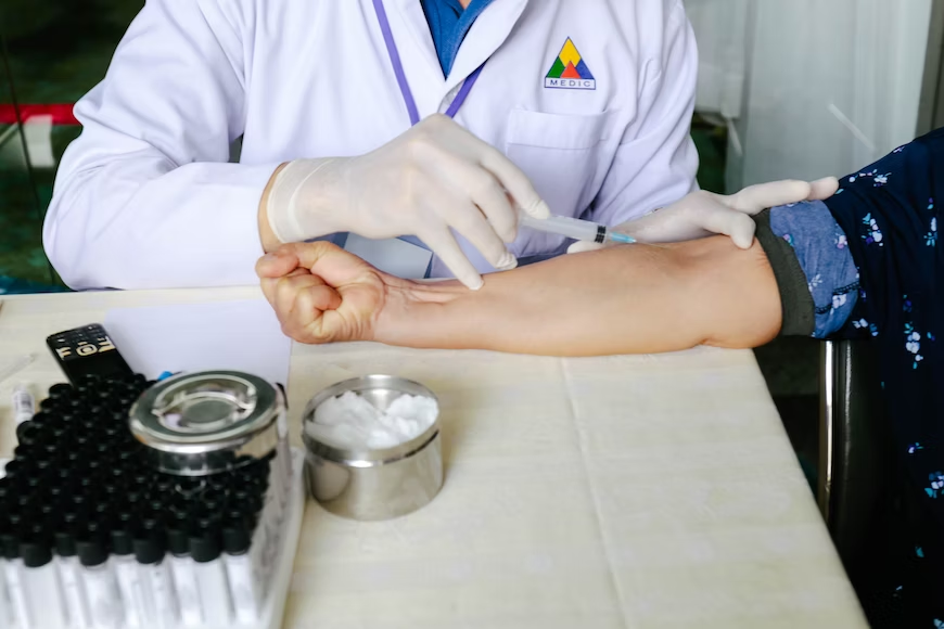 A nurse injecting a needle on a patients arm