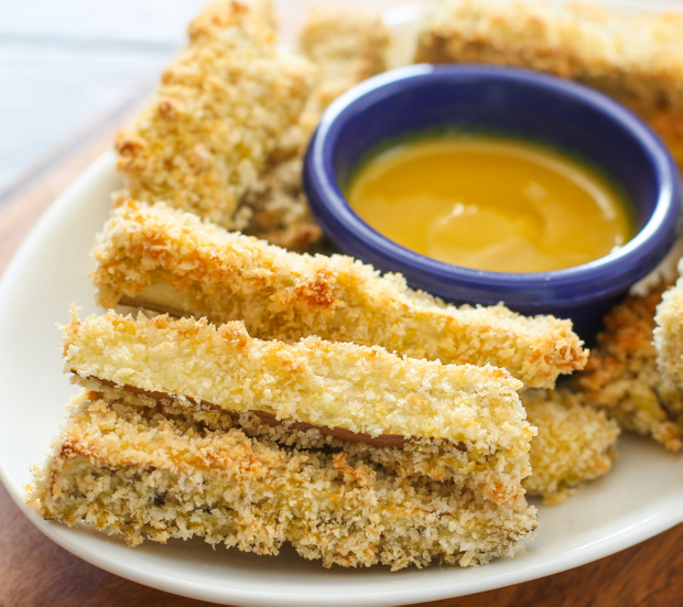 close-up photo of eggplant fries on a plate with dipping sauce