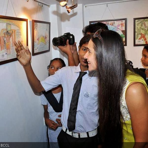 Young artiste shares his views with actress Tara Sharma at the launch of children painiting exhibition, held in Mumbai, on October 9, 2013. (Pic: Viral Bhayani)