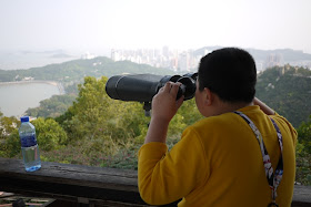Boy looking through binoculars at Jingshan Park in Zhuhai