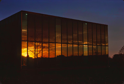 Reflection on the outside west wall of the U-M Computing Center Building at sunset