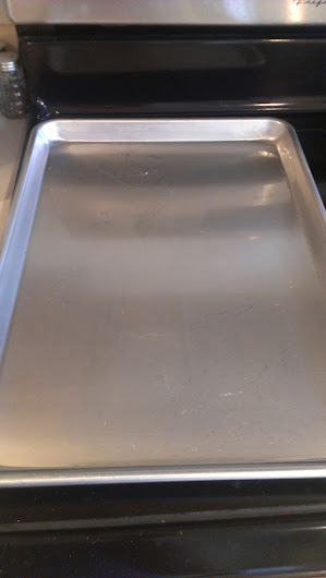 Grease baking sheet and preheat oven