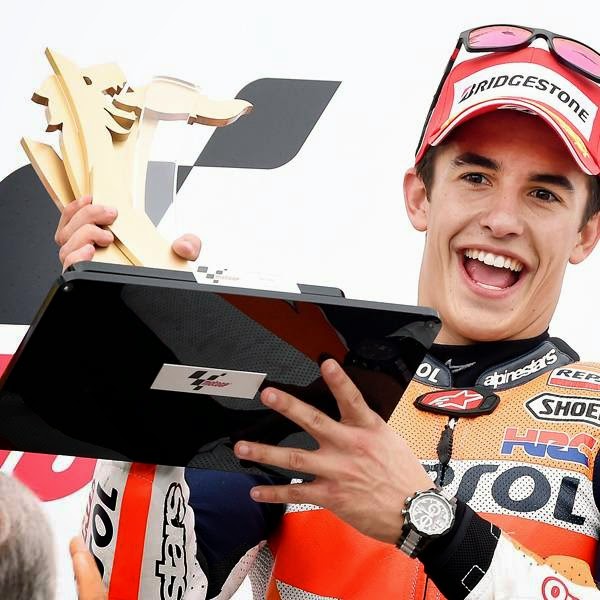 First placed Marc Marquez from Spain lifts his trophy during the award ceremony for the MotoGP race at the Sachsenring circuit in Hohenstein-Ernstthal, on July 13, 2014. 