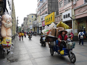 woman driving a motorized tricycle cart in Yangjiang, China