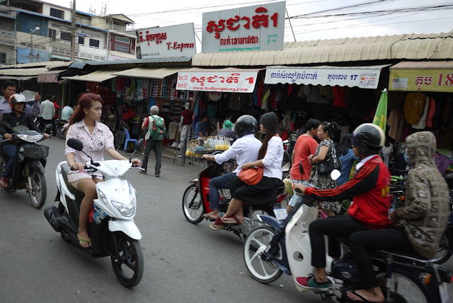 young woman with dyed hair on a motorbike