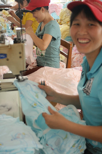workers at a baby clothing factory, China