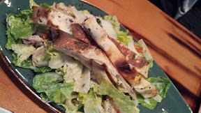 Wildwood Restaurant Lunch entree of tandoori roasted chicken romaine salad with creamy garlic dressing, pickled chiles, grilled onions, naan
