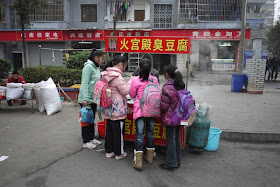 students at a stinky tofu street stand in Hengyang, Hunan province, China