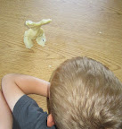 Child using playdough to make a model of a person.