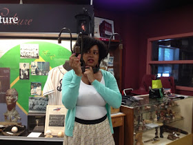 H. Blair Newby, Executive Director of Chatham-Kent Black Mecca Museum, Holding a bell on a slave yoke.