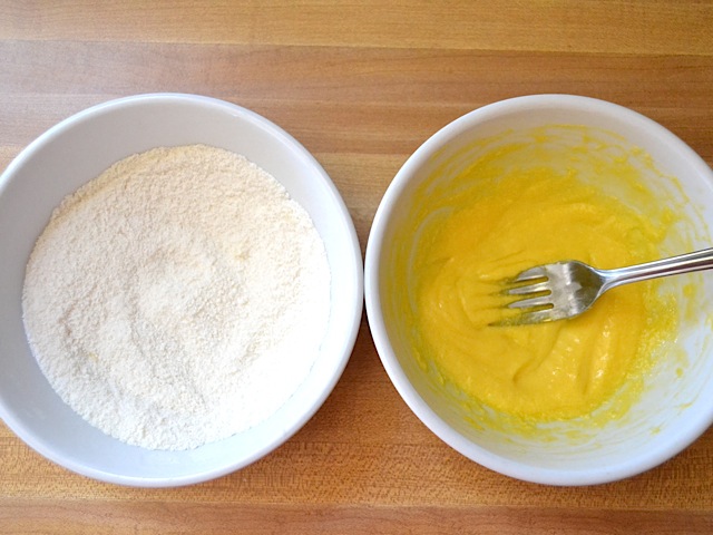 bowl of flour and sugar and bowl of whisked eggs 