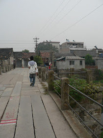 person walking on an old bridge in Tongcheng, Anhui, China