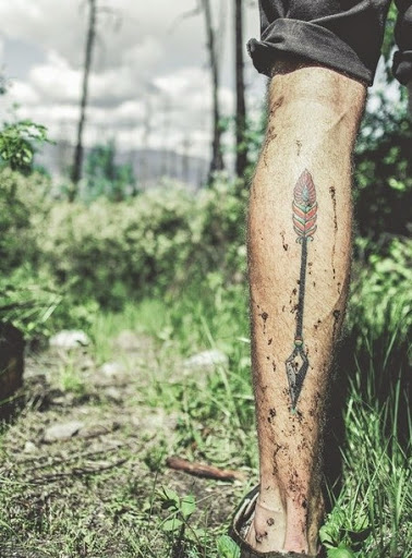 arrow tattoos on his leg