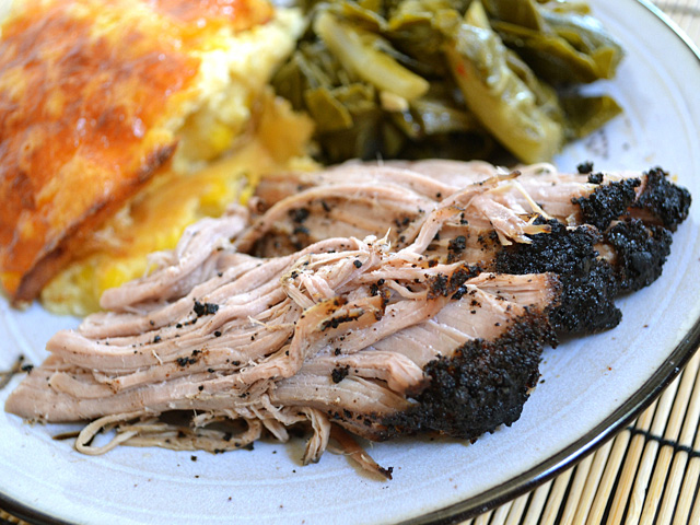 Coffee Rubbed Pork Roast on plate with side dishes 