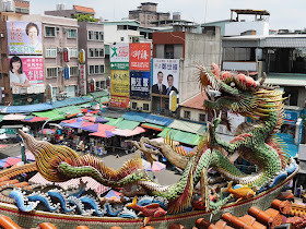 dragon in front of a market scene