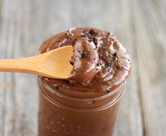 close-up photo of a spoon scooping up some nutella spread
