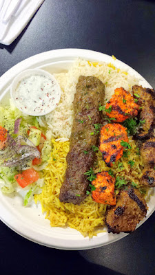 Arabian Nights Cafe Mixed Grill Supreme entree of Three skewers of chicken, lamb and kafta kabob served with rice, small salad and a side of cucumber yogurt.