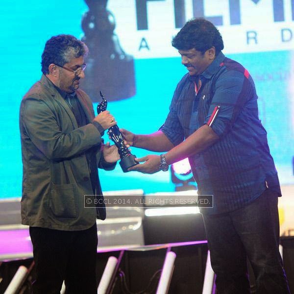 Shyamaprasad receives Best Director (Malayalam) Award for movie Artist from R Parthiepan during the 61st Idea Filmfare Awards South, held at Jawaharlal Nehru Stadium in Chennai, on July 12, 2014.