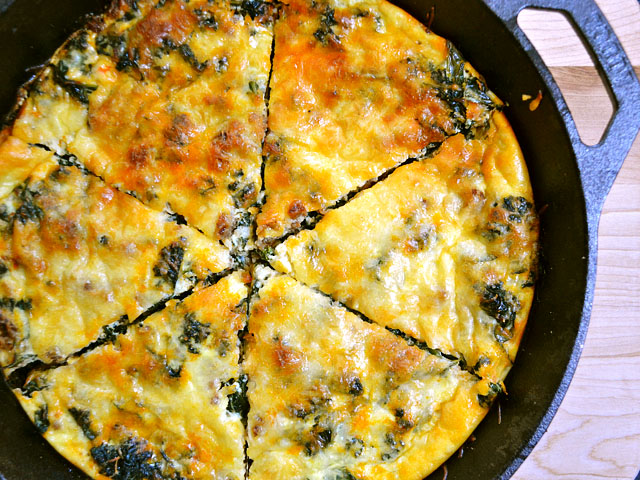 close up of chorizo and kale breakfast fritatta in cast iron skillet 