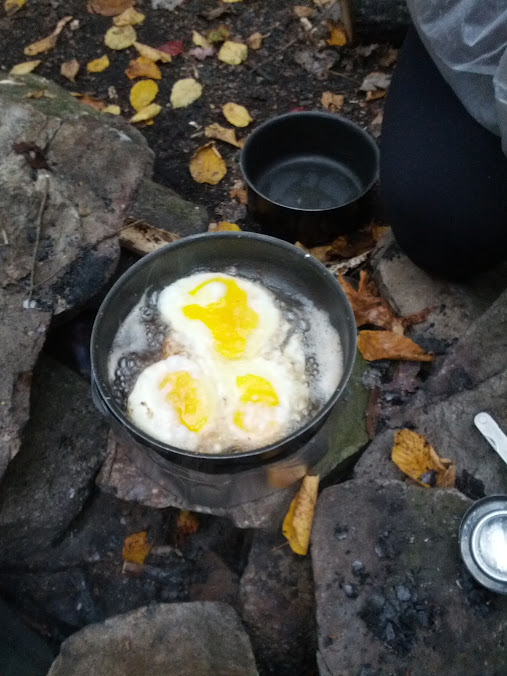 Eggs in Bacon fat over a pepsi-can stove