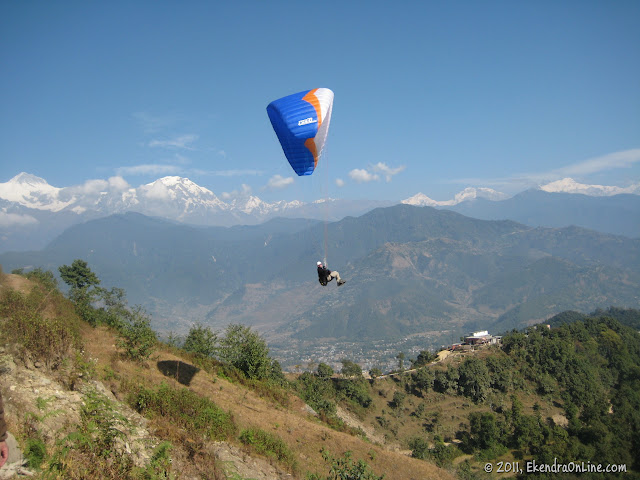 Close up: Paragliding from Sarangkot, Machhapuchhre on the background