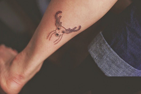 small deer tattoo on leg