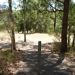 Metal post in footpath with a large grassy clearing in Richley Reserve (401941)