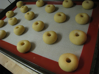Perfectly even holes punched into the cookies dough and ready for filling with jam!