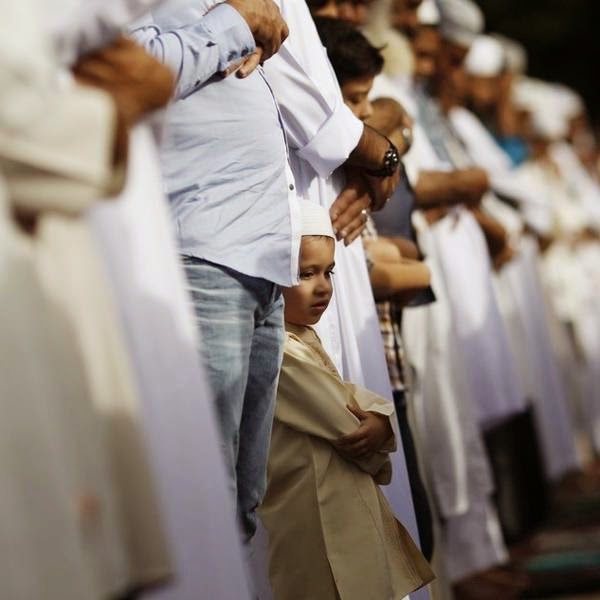 A boy is seen during a morning prayer session to celebrate Eid al-Fitr at the Santa Maria La Antigua University car park, in Panama City.