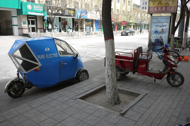 two very differently designed three-wheeled motorized vehicles in Yinchuan, China
