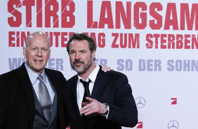 Cast members Bruce Willis and Sebastian Koch pose on the red carpet for the premiere of the movie 'Stirb Langsam - Ein Guter Tag zum Sterben' (A Good Day to Die Hard) in Berlin February 4, 2013. The movie opens in German cinemas on February 14. 