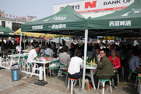 many people drinking under tents at Nanmen Square in Yinchuan, Ningxia, China