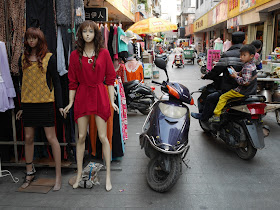 mannequins and man & young boy on a motorbike in Yangjiang, China