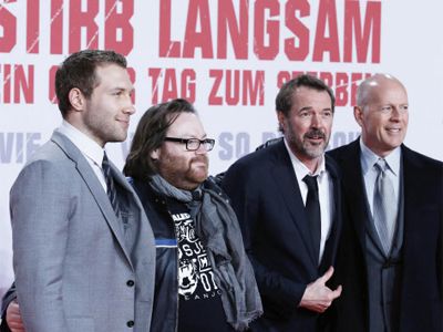 Jai Courtney (L-R), John Moore, Sebastian Koch and Bruce Willis pose on the red carpet for the premiere of the movie 'Stirb Langsam - Ein Guter Tag zum Sterben' (A Good Day to Die Hard) in Berlin February 4, 2013. The movie opens in German cinemas on February 14. 
