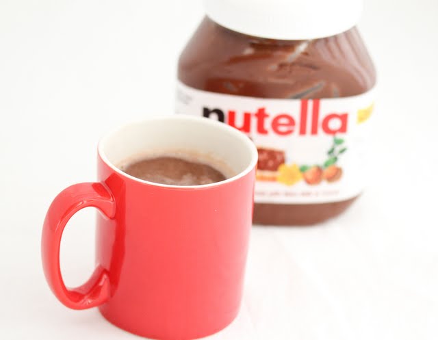 nutella hot chocolate with a jar of nutella in the background