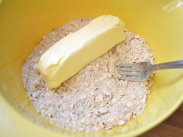 oat crumble ingredients in mixing bowl with fork 