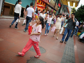 girl carrying a large bottle of Wang Lao Ji.